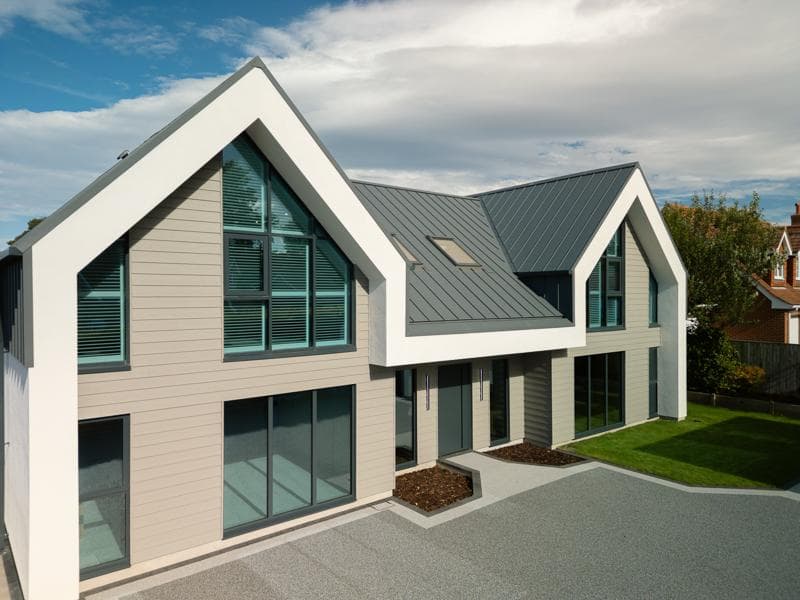 Aerial view of GreenCoat PLX Pural BT standing seam roof in Anthracite